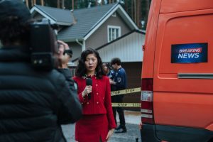 Female reporter in red with microphone reporting live at an outdoor crime scene with a news van. — Die beliebtesten Tischspie
