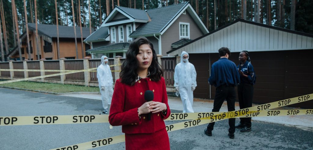 Journalist reporting from a crime scene with STOP tape and forensic team in the background. — FastPay Casino: Lightning-Fast