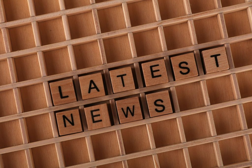 Wooden letter blocks spelling 'Latest News' on a grid surface. Ideal for media concepts. — Sensible Medical insurance Prepara