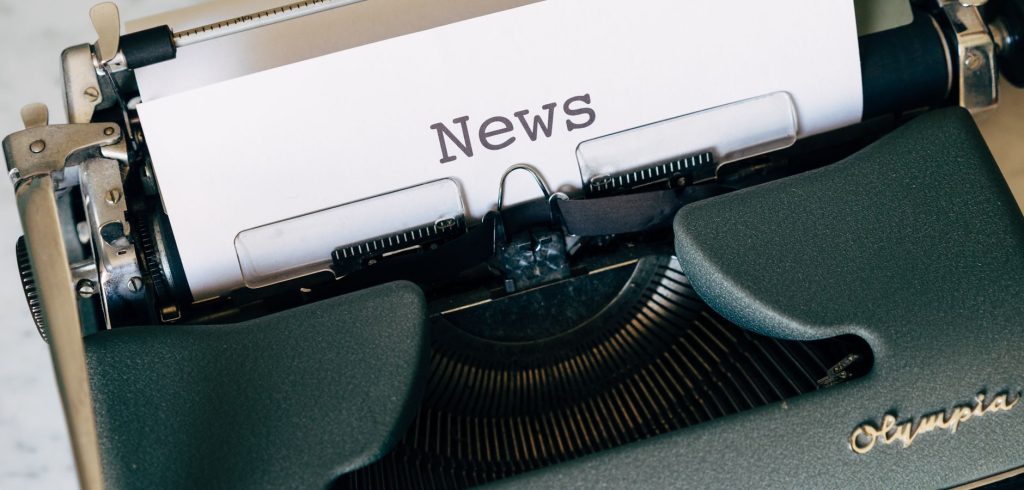 Close-up of a vintage Olympia typewriter with paper reading 'news'. Perfect for classic journalism themes. — SlotsMagic Casin
