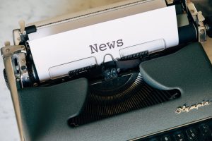 Close-up of a vintage Olympia typewriter with paper reading 'news'. Perfect for classic journalism themes. — SlotsMagic Casin